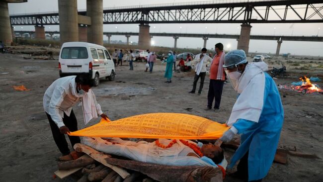 The Latest: India's double whammy: Rising cases, few shots