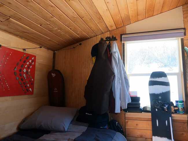 I spent 9 months in a tiny home on my employer's property with just enough room for my bed and snowboards - here's what it was like
