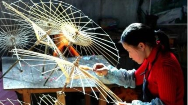 Traditional oil-paper umbrellas unfurl with flying colors