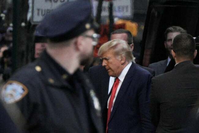Trump arrives in New York for surrender, opposes TV court coverage