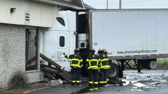Transport truck collides with building off Fredericton roundabout