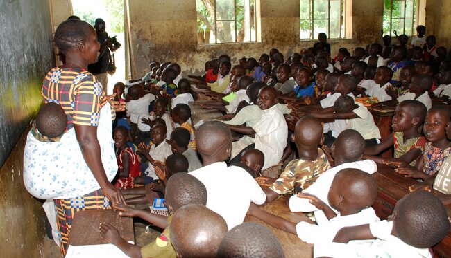 Meet 49-year-old who teaches with baby on her back