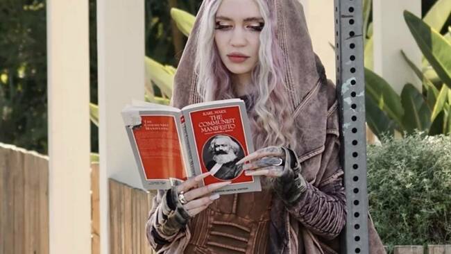 Singer Grimes trolls paparazzi by posing with The Communist Manifesto after split with Elon Musk; netizens can't stop laughing