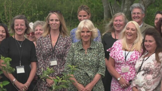 Queen all smiles as she plants a tree at women's centre