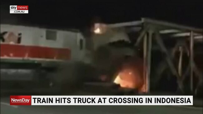 Train in Indonesia bursts into flames after colliding with truck