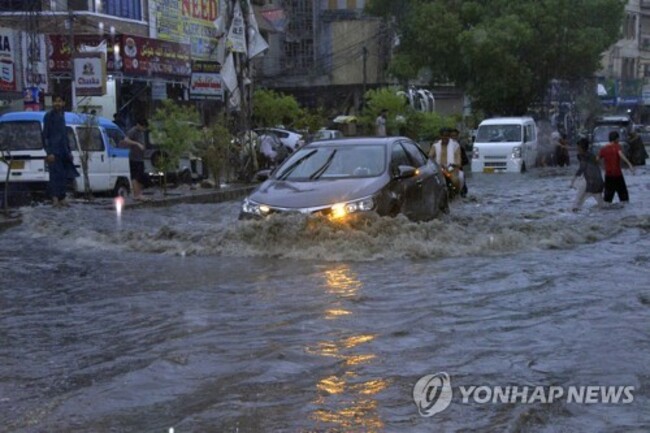 CORRECTION Pakistan Monsoon Rains