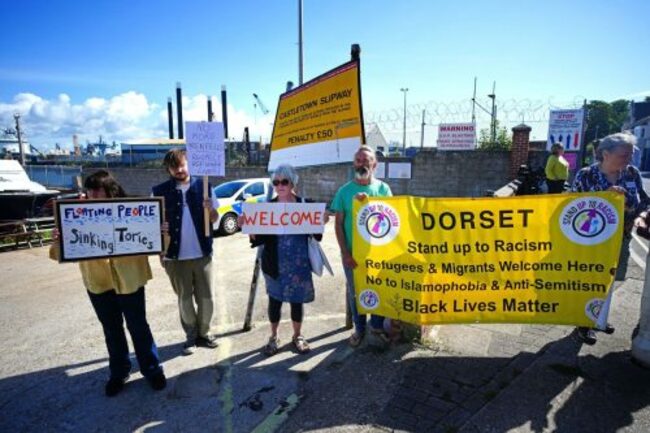 Migrants moved to housing barge moored in southern UK as government seeks to cut asylum-seeker costs