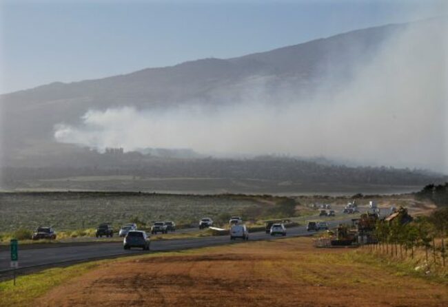 Hawaii wildfires burn homes and force evacuations, while strong winds complicate the fight