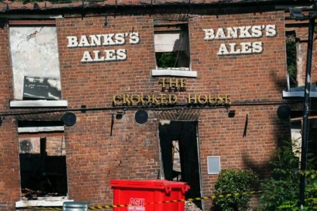 Angry villagers in England call for the quirky Crooked House pub to be rebuilt following demolition