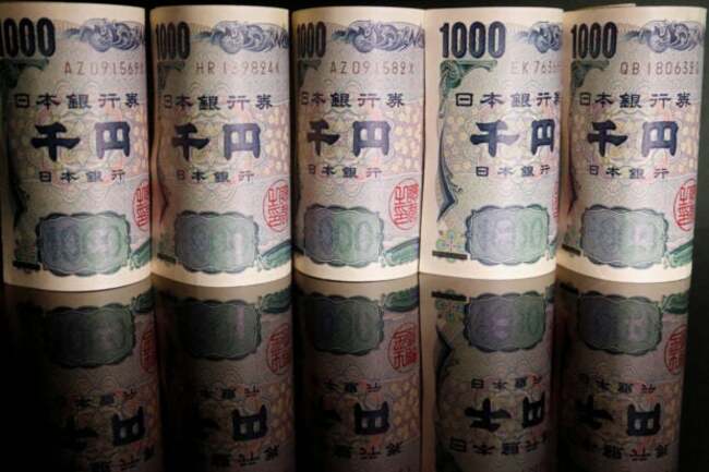 Japan's policymakers hold fire as yen enters intervention range