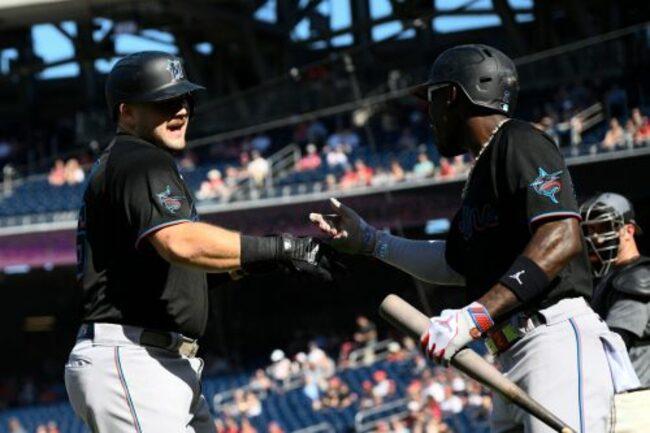 Cueto wins in his return as Burger hits 2 of the Marlins' 4 home runs in win over the Nationals