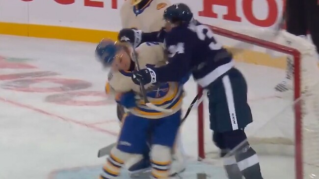 Matthews crosschecks Dahlin up high in front of the Sabres’ net