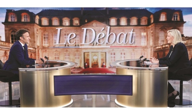 Macron, Le Pen clash over living costs in poll debate