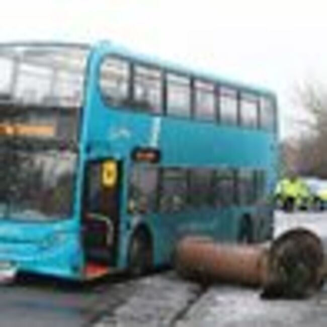 UK snow chaos as bus skids on ice and knocks down landmark in Liverpool park