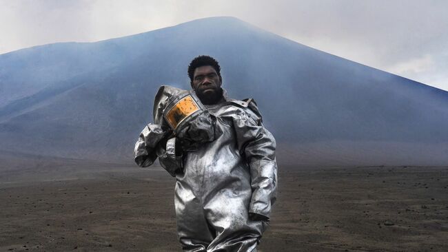 Vanuatu's 'barefoot volcanologist' stands at ash- and sulfur-spewing Mount Yasur in award-winning photograph
