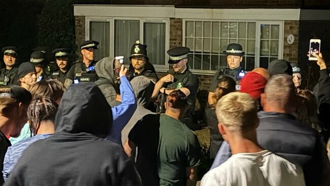 Police injured as protesters descend on homes for asylum seekers in England