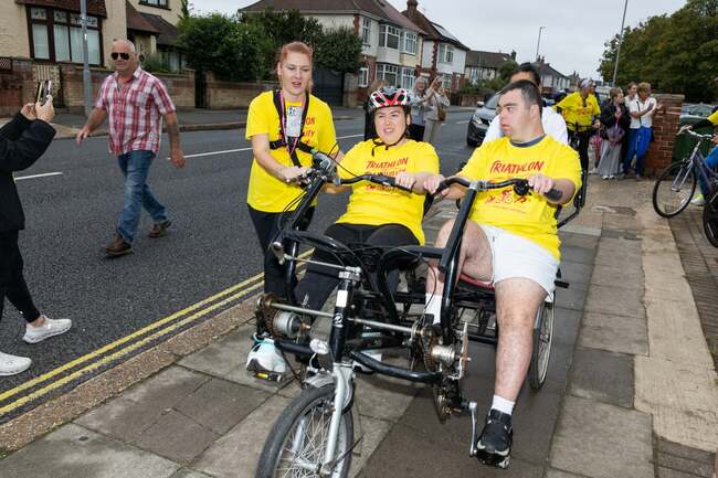 Supported living residents cycle, run and swim to raise £13,000 for accessible garden