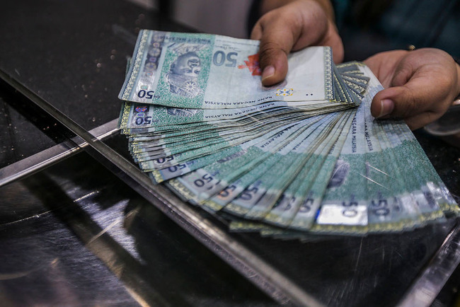 Ringgit opens slightly lower as investors remain wary